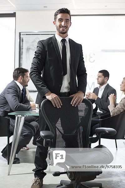 Portrait of confident businessman in boardroom