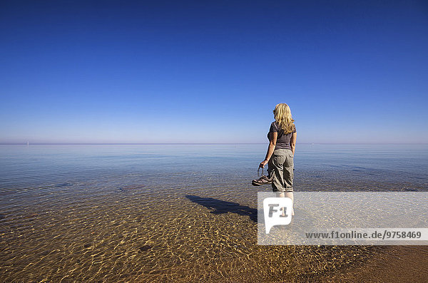 USA  Michigan  woman relaxing at Lake Huron