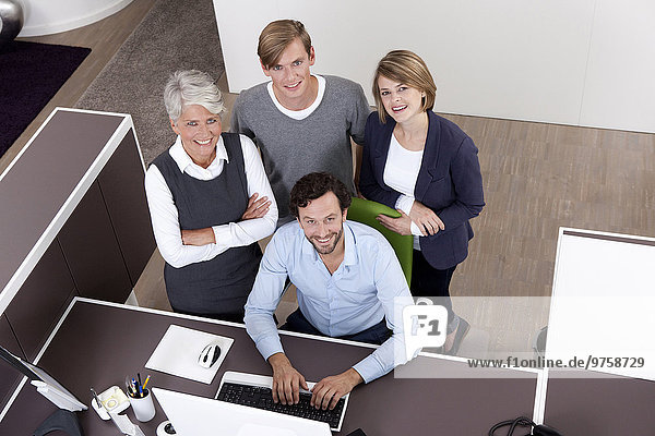 Smiling business team at desk in office