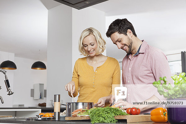 Couple cooking in kitchen