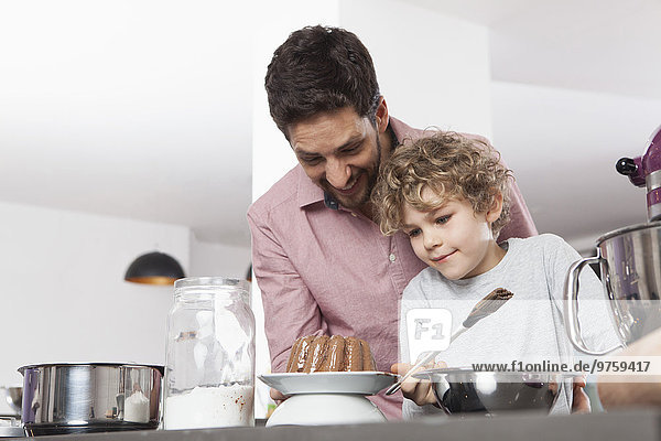 Father and son baking in kitchen