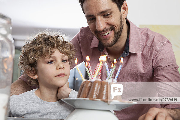 Father and son with birthday cake