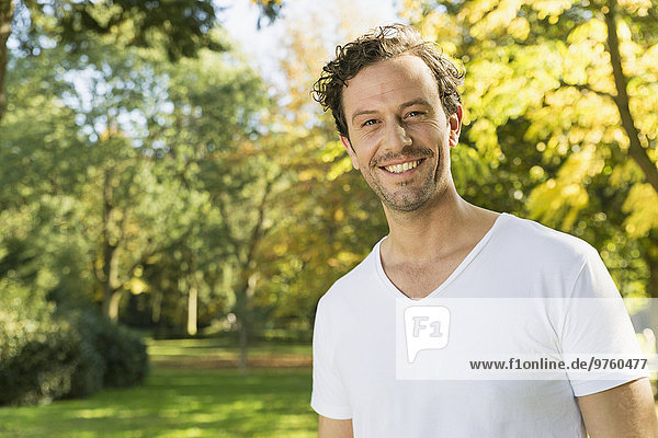 Portrait of smiling man in a park