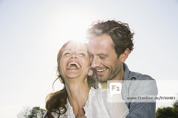 Laughing couple at backlight