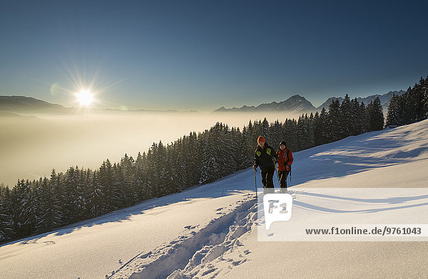 Austria  Tyrol  Schwaz  couple snowshoeing