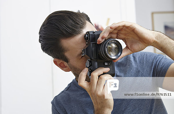 Man taking photo with vintage camera