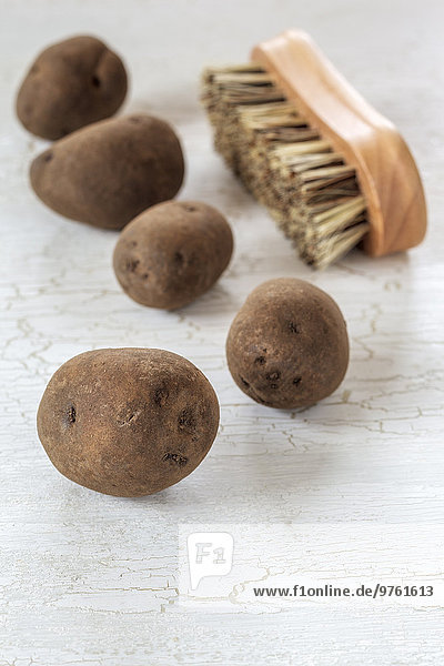 Blue Congo potatoes and vegetable brush