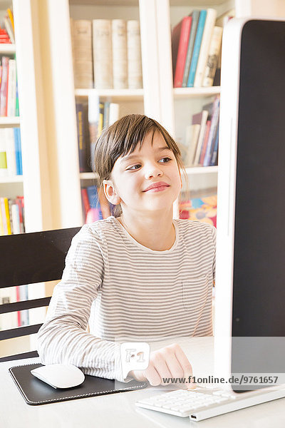 Portrait of smiling girl spending time at computer