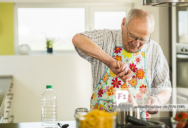 Senior man cooking in kitchen