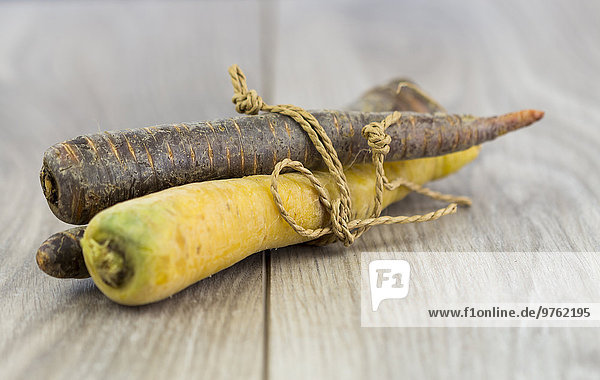Yellow and prple carrots  organic vegetables on wood