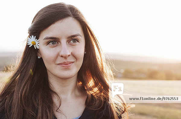 Portrait of smiling woman wearing flower