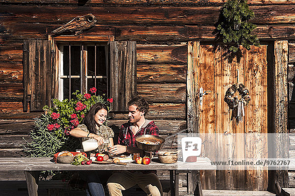 Austria  Altenmarkt-Zauchensee  couple having a break at alpine cabin