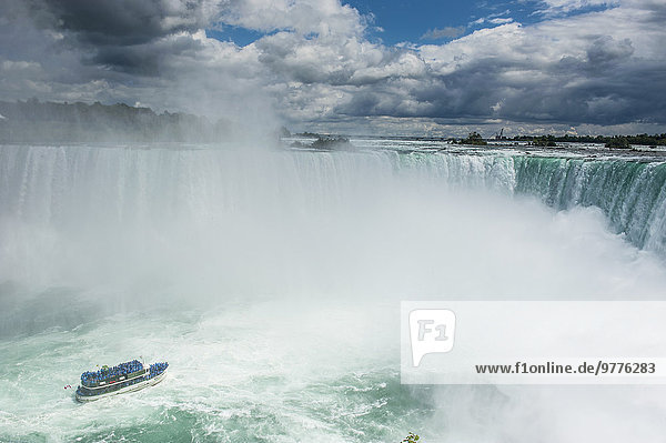 Tourist boat in the mist of the Horseshoe Falls (Canadian Falls)  Niagara Falls  Ontario  Canada  North America