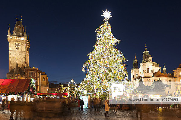 Christmas Market at Old Town Square with Gothic Old Town Hall  Jan Hus Monument and Baroque Church of St. Nicholas at twilight  Old Town  UNESCO World Heritage Site  Prague  Czech Republic  Europe