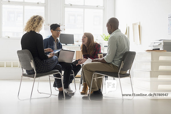 Friends having business meeting in office