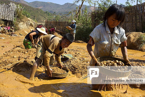 Boys searching for ruby stones in Mogok mining sites  Myanmar (Burma)  Asia