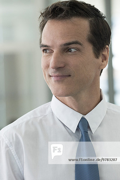 Businessman looking away in thought  smiling  portrait