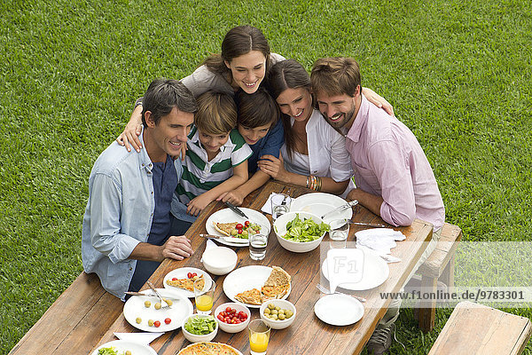 Family and friends huddle for group picnic photo