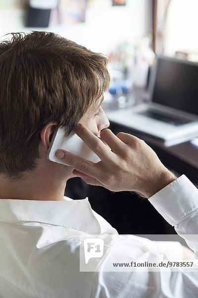 Office worker using cell phone  side view