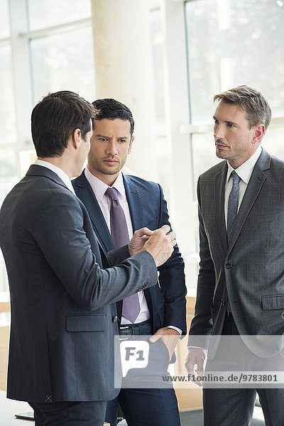 Businessmen engaged in serious discussion