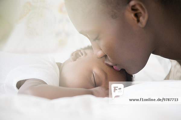 Close up of Black mother kissing forehead of baby boy