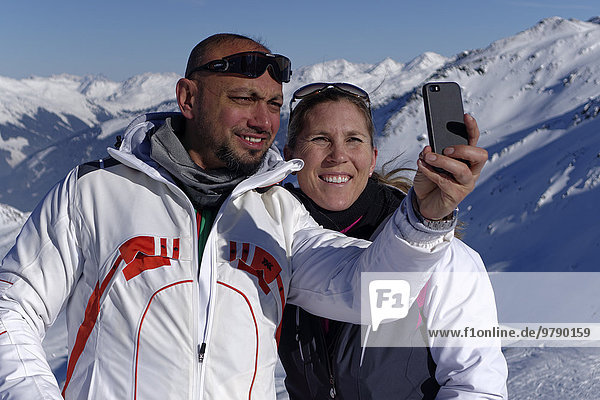 Skiers  couple taking a selfie  Hochfügen in Zillertal valley  Tyrol  Austria  Europe