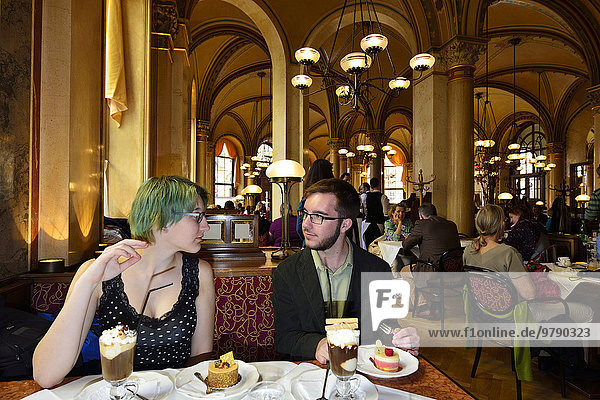 Young couple sitting at a table in the traditional Café Central  Innere Stadt district  Vienna  Austria  Europe