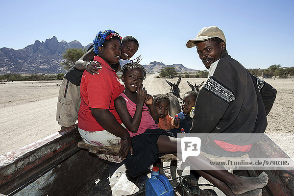 Local family travelling on a donkey carts  near Spitzkoppe  Namibia  Africa