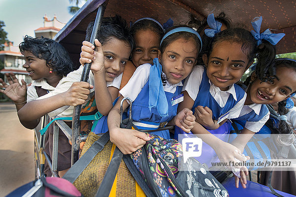School children in school uniforms sitting in a rickshaw  Alappuzha  Kerala  India  Asia