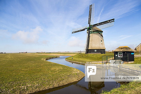 Historic windmill from 1598 by a canal  Burgervlothbrug  North Holland  The Netherlands  Europe