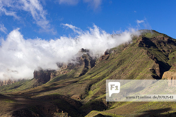 Wispy clouds over a mountain ridge Santa Lucia de Tirajana Gran Canaria Canary Islands Spain Europe