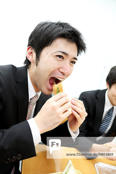 Young Japanese business people having lunch together