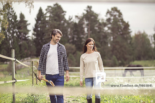 Happy mid adult couple walking in organic farm