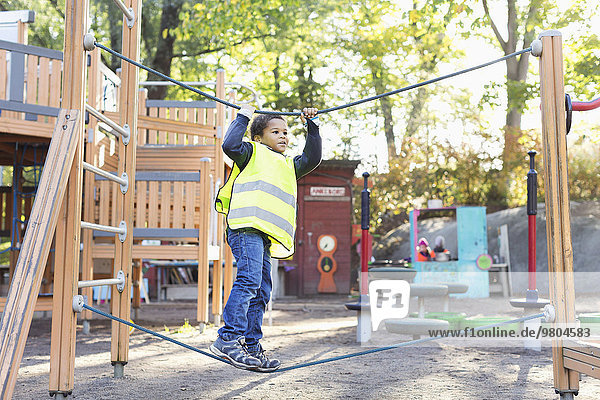 Boy balancing on rope at playground