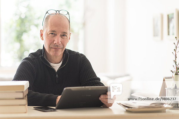 Portrait of mature man working in home office