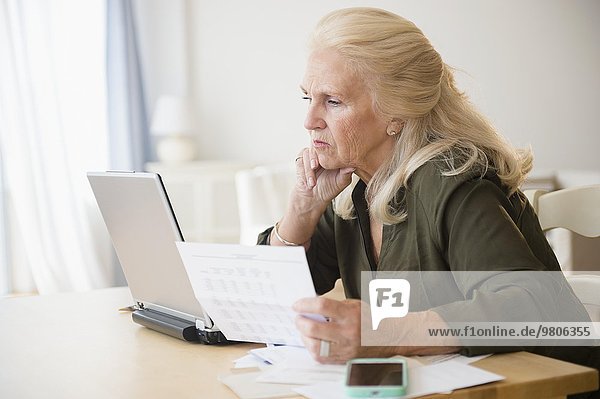 Senior woman paying bills online
