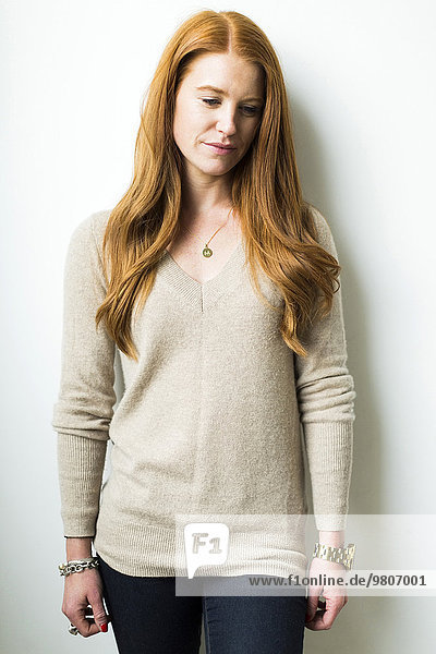 Portrait of woman with long red hair