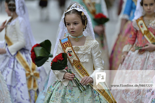 Fallas festival  girls in a traditional costume during the parade in the Plaza de la Virgen de los Desamparados  Valencia  Spain  Europe