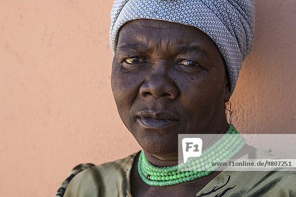 Einheimische Frau mit Kopftuch und grüner Halskette  Portrait  bei Spitzkoppe  Namibia  Afrika