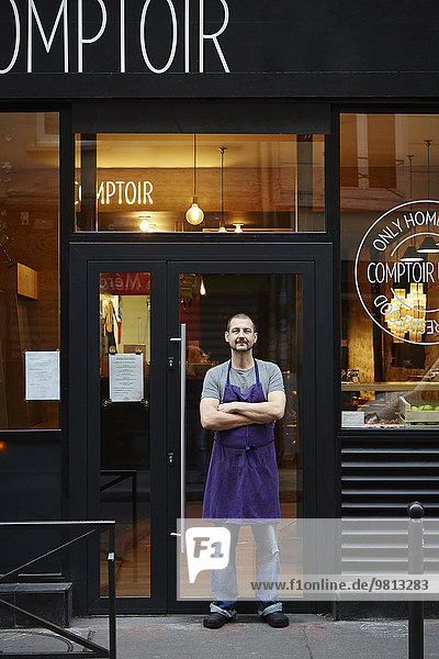 Portrait of restaurant owner  outside his business