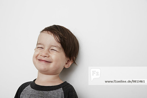 Portrait of male toddler smiling with eyes closed