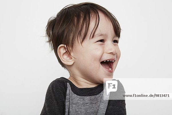 Portrait of cute male toddler laughing