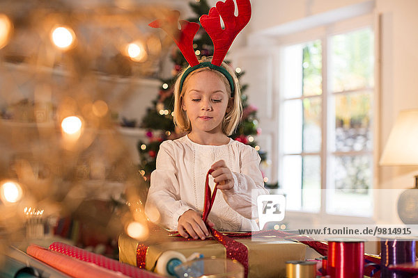 Girl wrapping Christmas presents