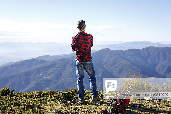 Hiker enjoying view from hilltop  Montseny  Barcelona  Catalonia  Spain