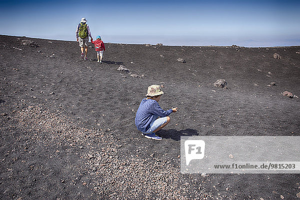 Senior woman and two grandsons on Mount Etna  Catania  Sicily  Italy