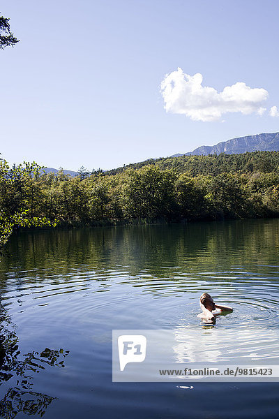 Wanderer schwimmen im See  Montiggler Seen  Südtirol  Italien