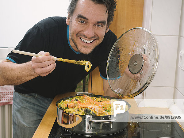 Man trying freshly cooked paella
