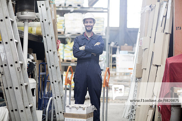 Smiling warehouseman in storehouse