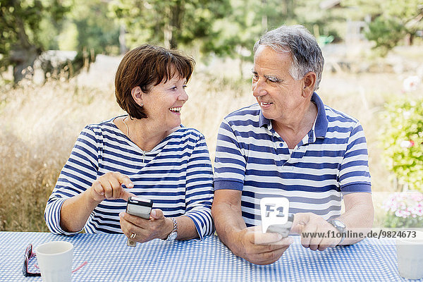 Mature couple with cell phones