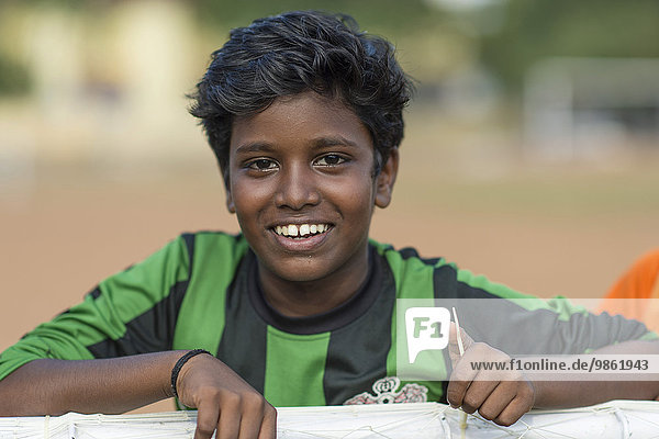 Boy  laughing  football jersey  Kochi  Cochin  Kerala  India  Asia